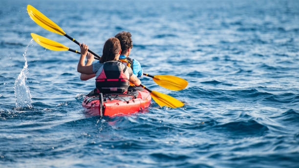 istock Kayakers rowing together in sea 1074257636