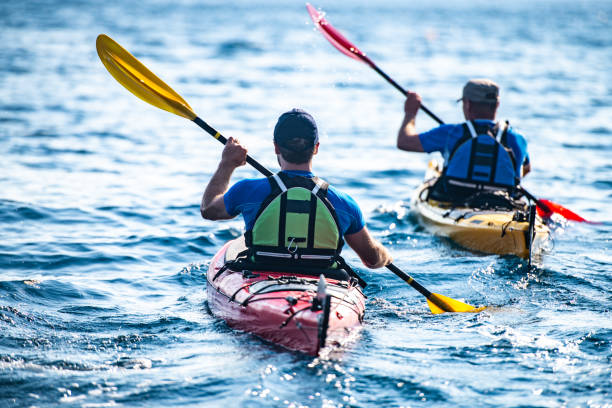 istock Kayakers rowing together in sea 1074257644