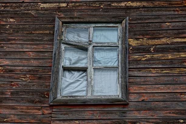 istock old window on brown wooden plank wall 1074258798