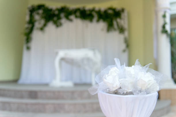 Elegant white wedding altar - baroque table with white lace - selective focus, space for text