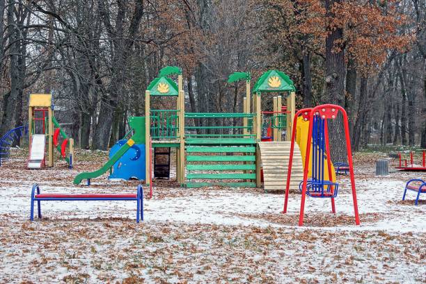 istock colored playground among trees in a winter park in white snow 1074260488