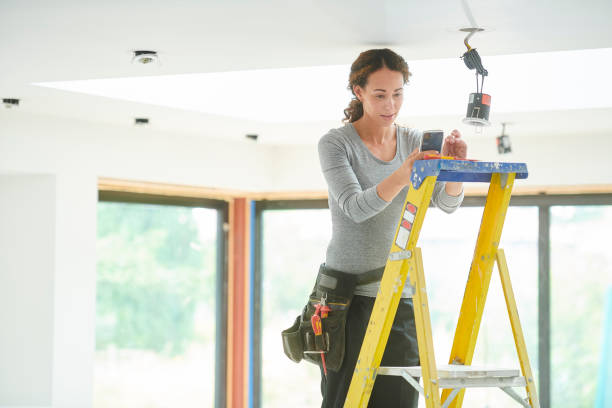 istock female electrician with smartphone 1074262222