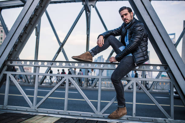 istock Young man sitting on the bridge 1074268944