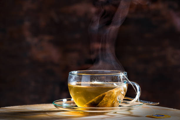 istock Glass cup with tea on wooden table 1074269336