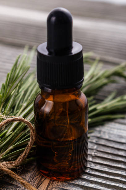 istock Rosemary essential oil on a gray wooden rustic background 1074277466