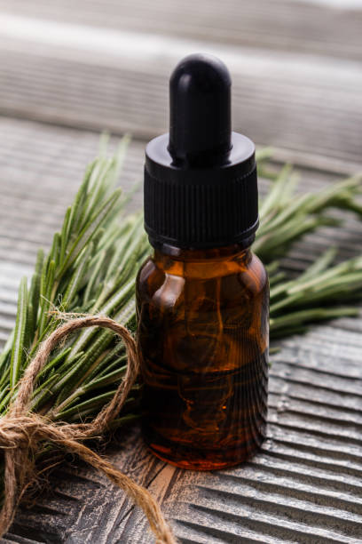 istock Rosemary essential oil on a gray wooden rustic background 1074277478
