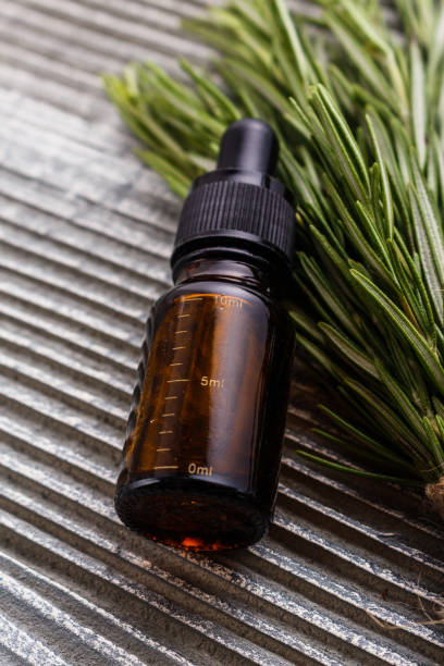 istock Rosemary essential oil on a gray wooden rustic background 1074277554