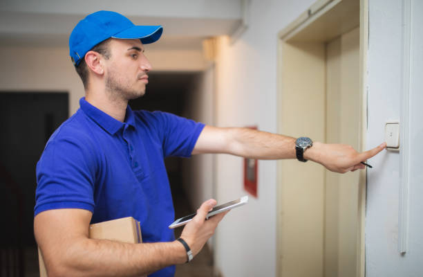 istock Postman with package at the door 1074277754