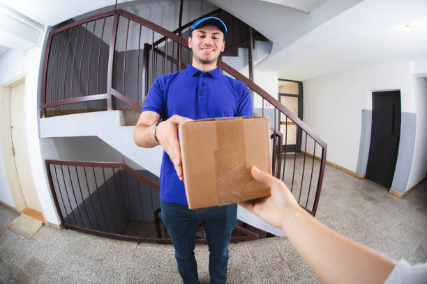 istock Postman with package at the door 1074278092