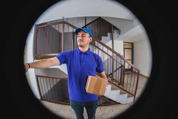 istock Postman with package at the door 1074278644