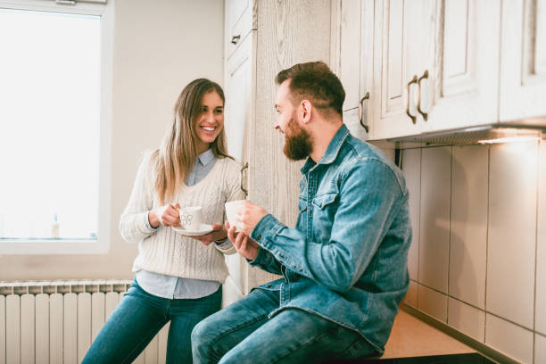 istock Young Couple Enjoying Morning Tea In a Kitchen 1074278918