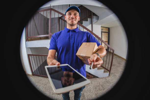 istock Postman with package at the door 1074280076