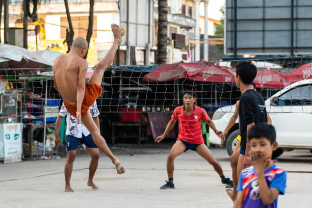 monk with people playing sepak takraw (rattan ball) together - sepaktakraw imagens e fotografias de stock