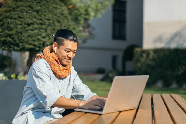 istock Mid adult Japanese is working on laptop 1074282142