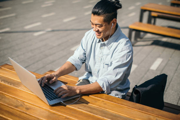 istock Mid adult Japanese is working on laptop 1074282512