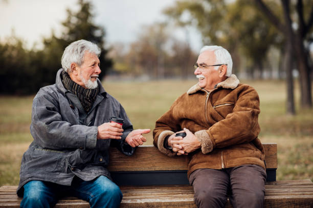 istock Happy men drinking coffee outdoors 1074284074