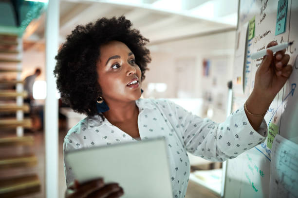 making sure all of the information is here - transparent holding glass focus on foreground imagens e fotografias de stock