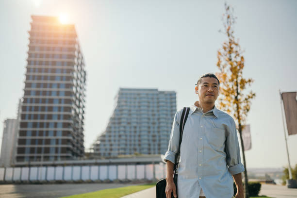 istock Mid adult Japanese walking to work 1074287042