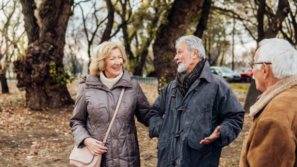 istock Happy mature friends in the park 1074287044