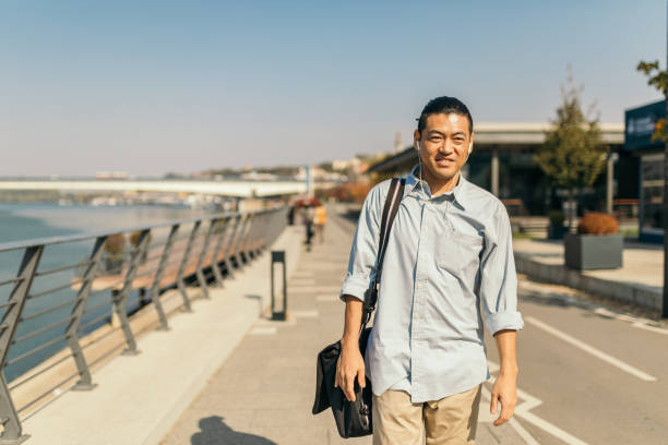 istock Mid adult Japanese walking to work 1074287048