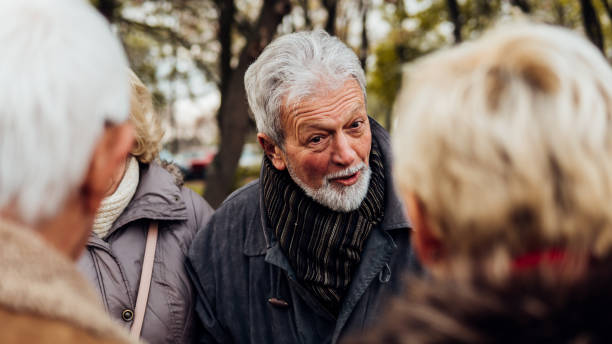 istock Mature man talking to friends 1074287088