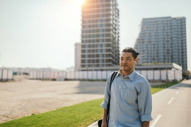 istock Mid adult Japanese walking to work 1074288442