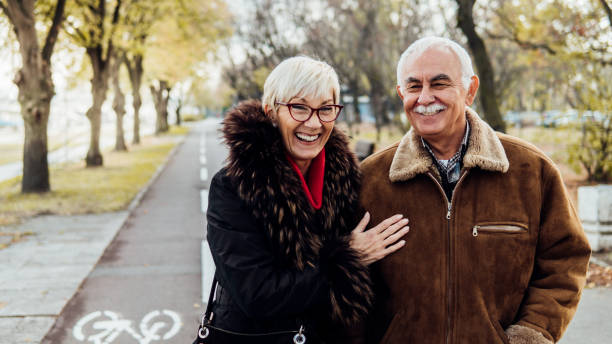 istock Senior couple smiling outdoors 1074288694