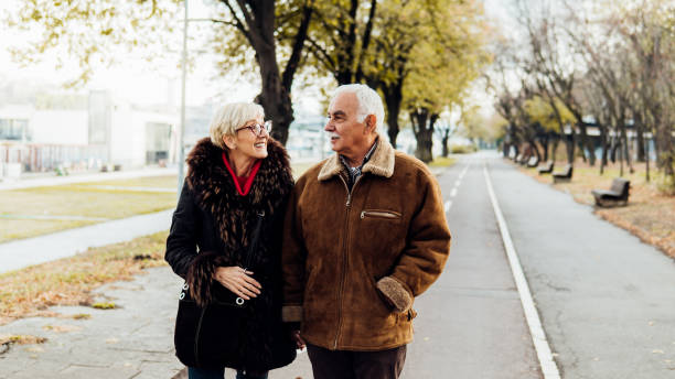 istock Couple walking in the park 1074288848