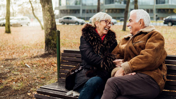istock Happy couple sitting in the park 1074288986