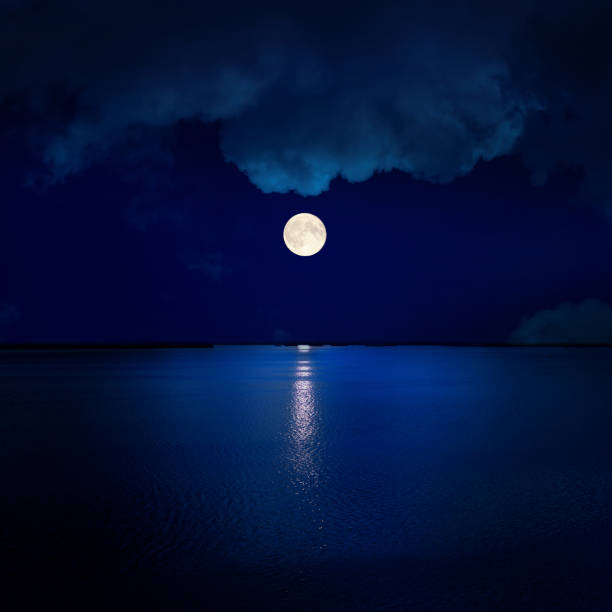 istock full moon in clouds over water 1074289292