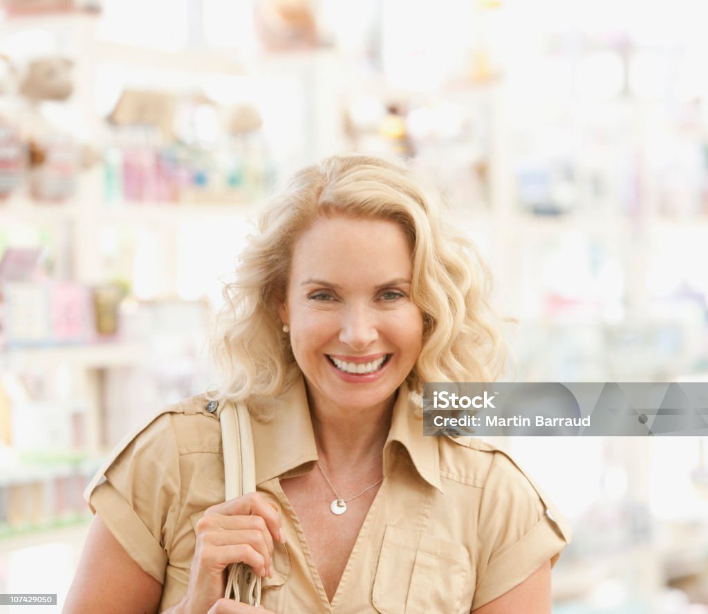 Femme souriant shopping dans le magasin - Photo de Sac à main libre de droits