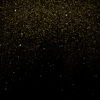 Gold glitter over black background