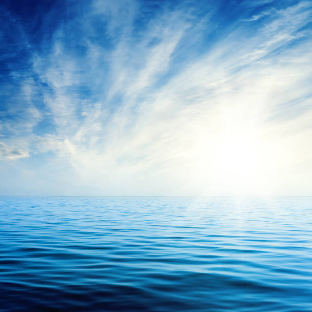 istock sunset in blue sky with clouds over dark sea 1074291972