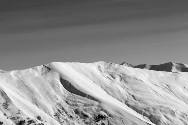 istock View on off-piste snowy sunlight slope with traces from avalanches at sun evening 1074292360