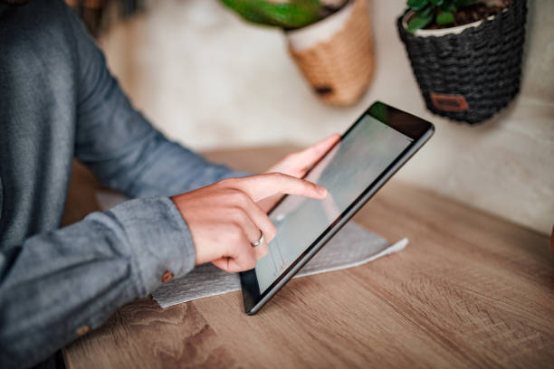 istock Close-up image of businessman using digital tablet. 1074293410