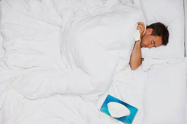 Photo of Sick man sleeping in bed