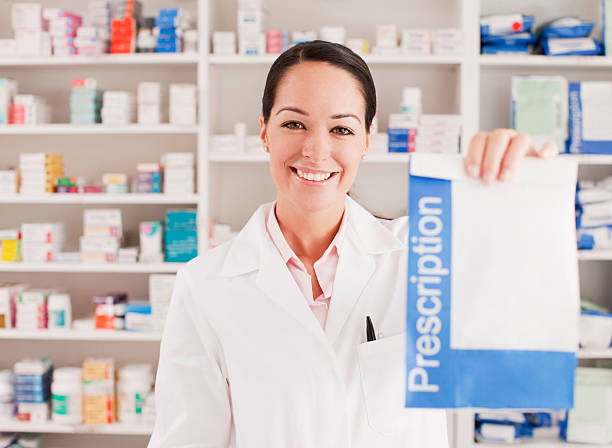 Pharmacist holding prescription in drug store  prescription medicine stock pictures, royalty-free photos & images