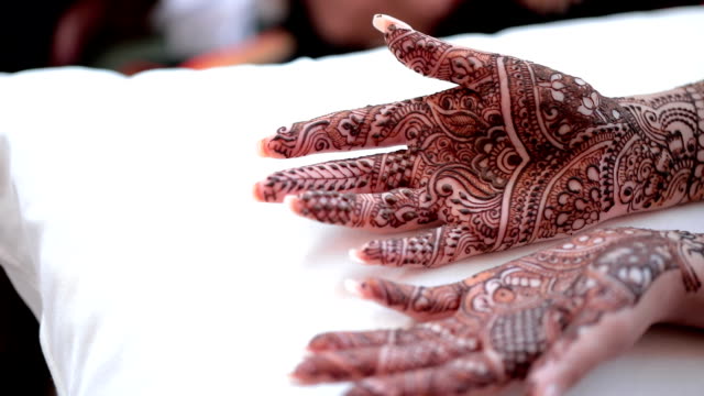 Close up of bride's hand with henna painted, Mehndi.