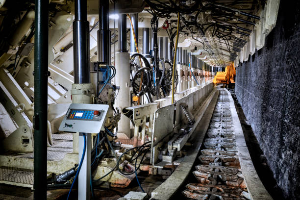 Coal mine underground corridor with support system and drilling machine Coal mine underground corridor with support system and drilling machine,  Bochum, Germany mining conveyor belt stock pictures, royalty-free photos & images