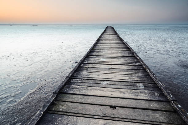 istock Boardwalk over wadden sea at dusk 1074326760