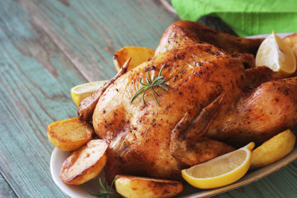 istock Whole roasted chicken with potatoes and lemon 1074368166