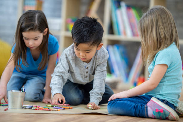 istock Children colouring together 1074374846