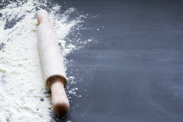 istock white flour and rolling pin on dark background 1074407396