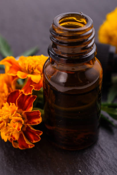 istock essential oil marigold on a dark stone background 1074436582