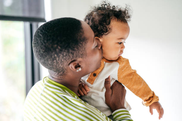 istock Mom kissing a baby 1074436644
