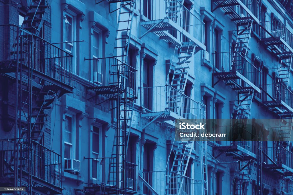 Block of old New York City buildings in blue Block of old New York City style buildings in blue color overlay effect Textured Stock Photo