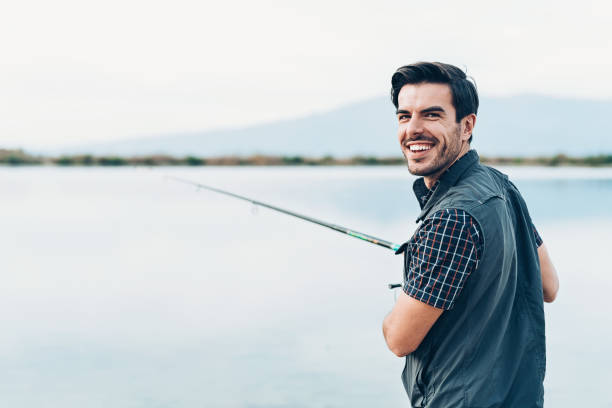 istock Young man fishing 1074451238