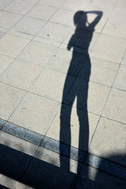 istock Shadow of a photographer with camera on the stone pathway 1074454178