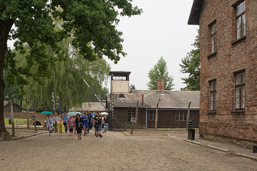 Oswiecim, Poland - July 11th 2018. Visitors in a tour group at the Auschwitz concentration camp