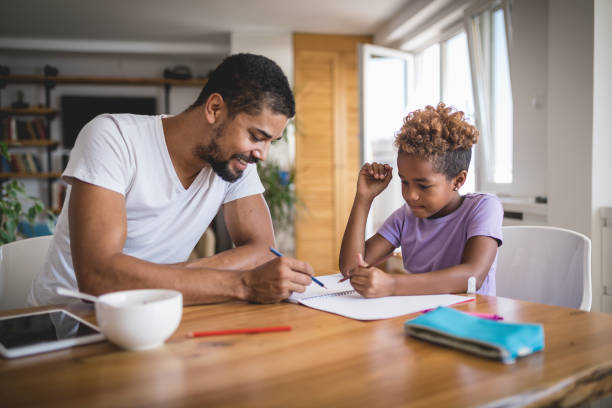 istock Father helping his daughter with homework 1074457238